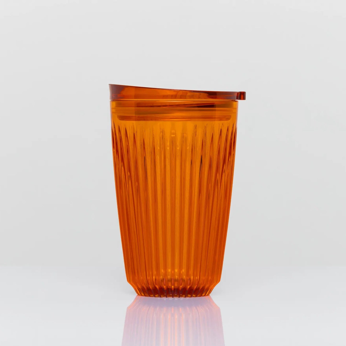 12 oz HuskeeRenew cup on white background. The cup is amber in colour and clear. There are vertical ridges running around the entire circumferance