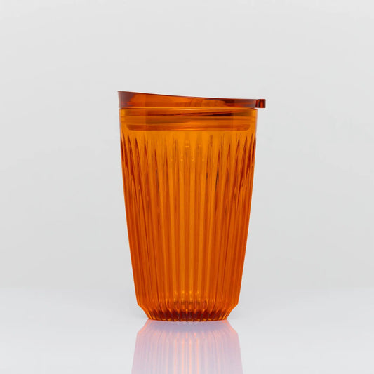 12 oz HuskeeRenew cup on white background. The cup is amber in colour and clear. There are vertical ridges running around the entire circumferance