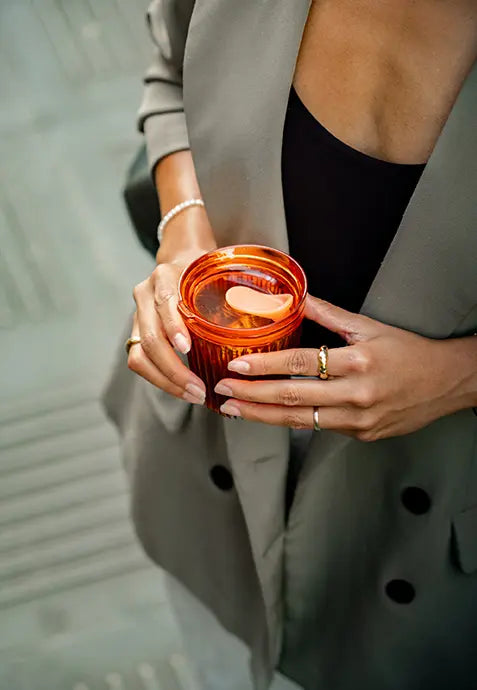 A woman holding a huskeerenew amber cup